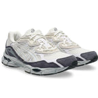 A pair of Asics athletic sneakers in white and dark gray, shown from a three-quarters angle on a clean white background.