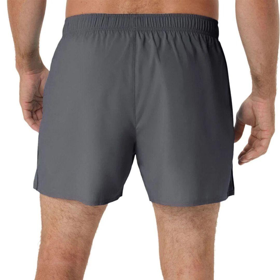 A person shown from the back wearing dark grey athletic Asics shorts against a plain white background.