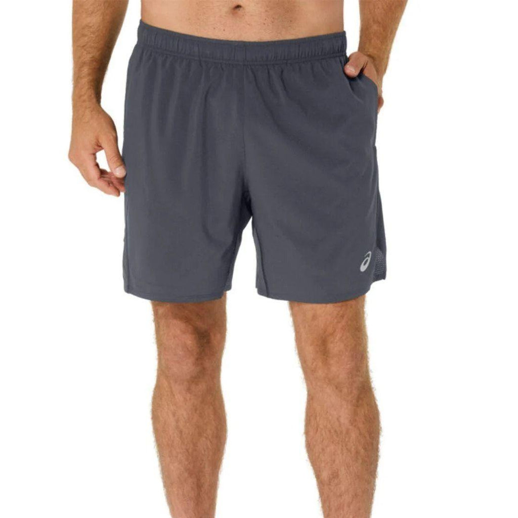 A man wearing dark grey athletic shorts with a small white Asics logo on the lower left leg, shown from the waist down against a plain white background.