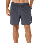 A man wearing dark grey athletic shorts with a small white Asics logo on the lower left leg, shown from the waist down against a plain white background.