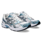 Asics pair of white and blue running shoes on a white background