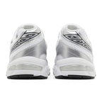 A pair of white and metallic silver athletic sneakers shown from the back, featuring mesh panels, a metallic synthetic upper, and a thick white cushioned sole with a black outsole.