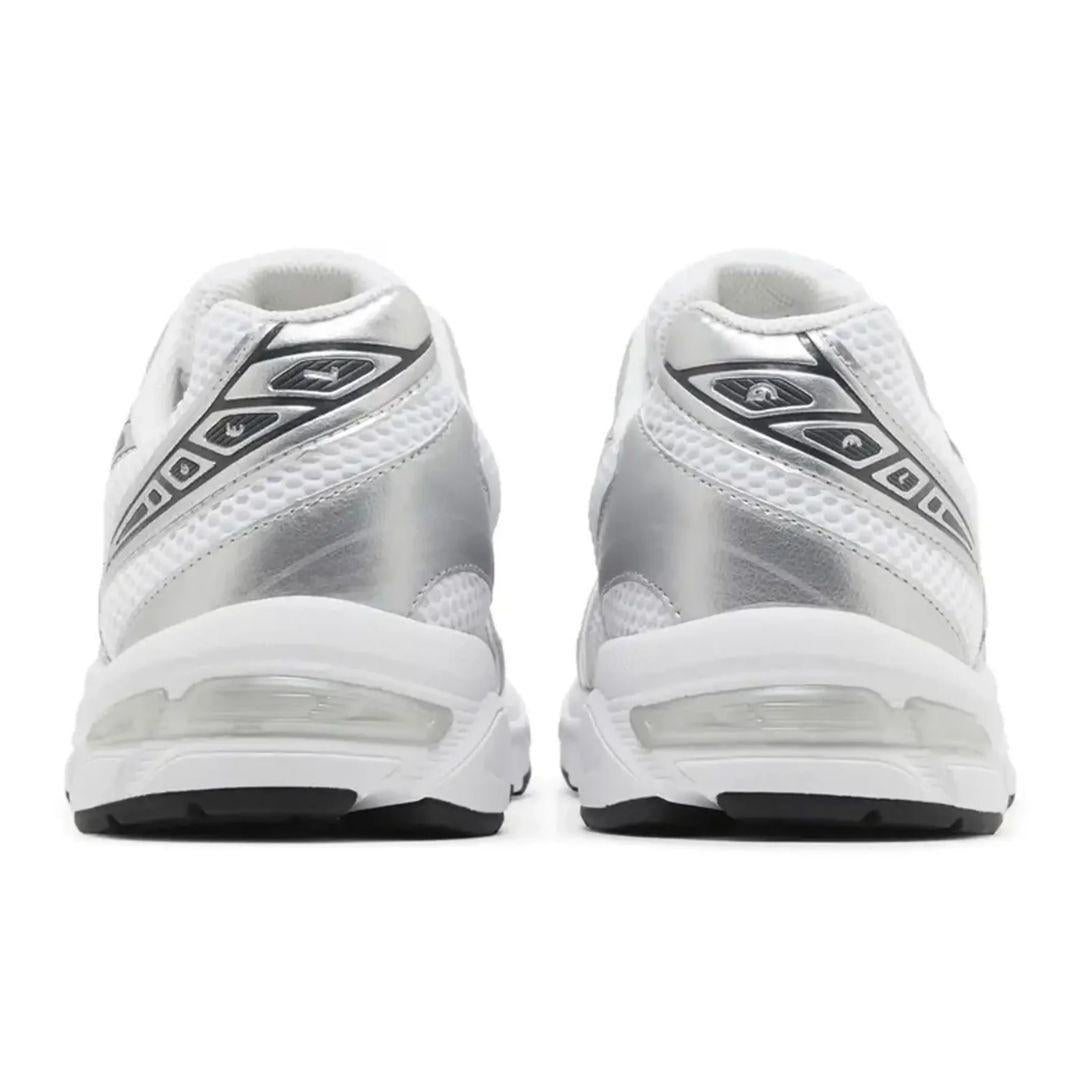 A pair of white and metallic silver athletic sneakers shown from the back, featuring mesh panels, a metallic synthetic upper, and a thick white cushioned sole with a black outsole.