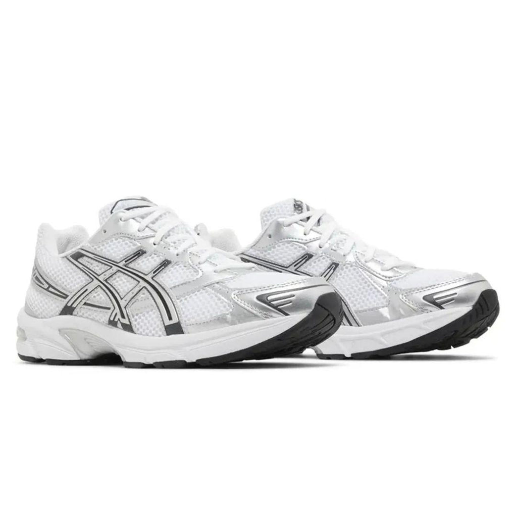 A pair of ASICS athletic sneakers in white, silver, and black, shown from a side profile view against a plain white background.