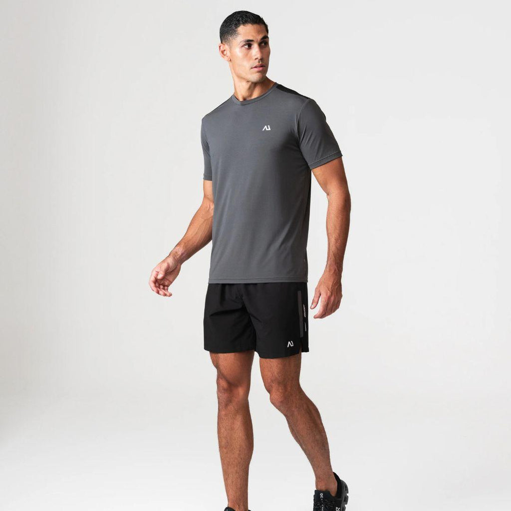 Agaru 'Carbon Black' SRG T-Shirt Set for men, front view on model of charcoal moisture-wicking seamless tee with black shoulder panel and Agaru logo, paired with black woven shorts