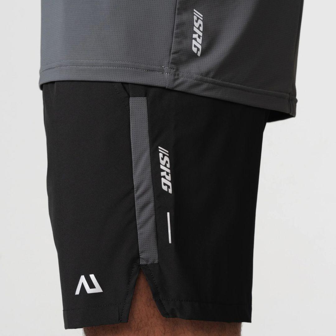 Agaru 'Carbon Black' SRG Shorts for men, close-up of the zipped side pocket, SRG logo print and Agaru branding on the black woven shorts