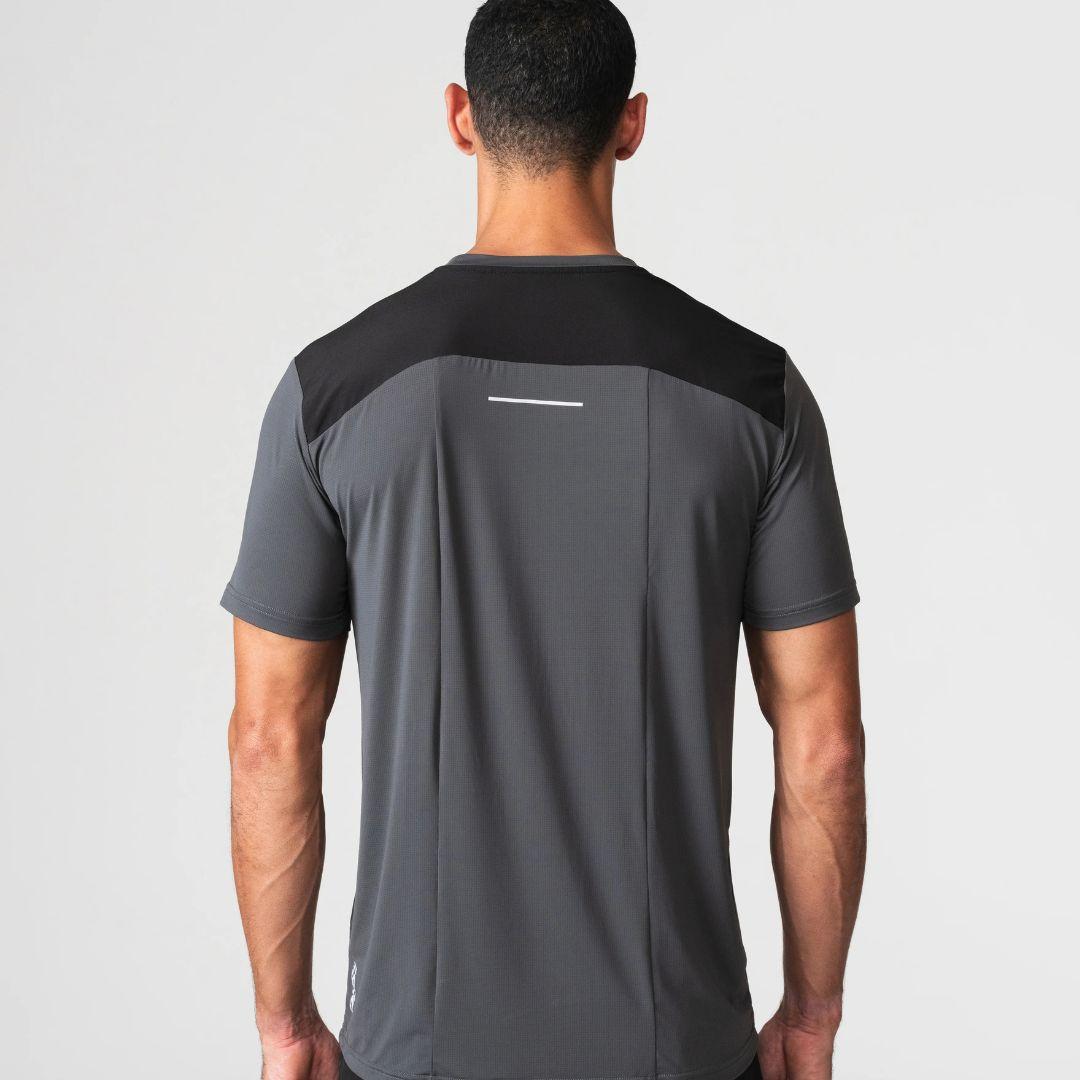 Agaru 'Carbon Black' SRG T-Shirt for men, back view on model showing the black panelled shoulder yoke, reflective back strip and seamless charcoal fabric