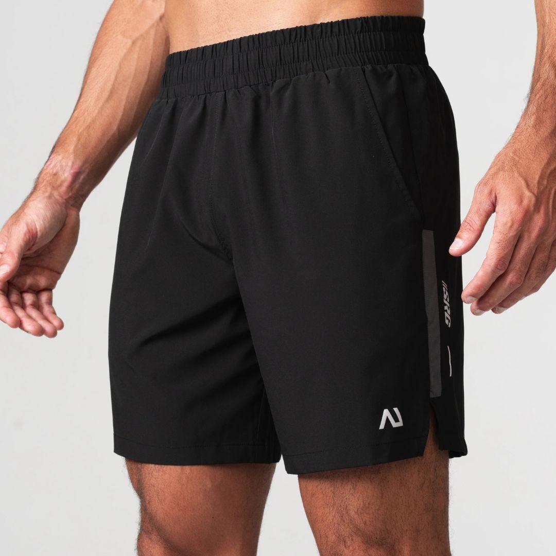 Agaru 'Carbon Black' SRG Shorts for men, front view on model of black woven training shorts with elasticated waistband, side pockets and SRG branding