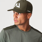 Agaru 'Deep Olive' SRG Cap for men, front three-quarter view on model of the olive structured cap with raised logo badge and curved brim