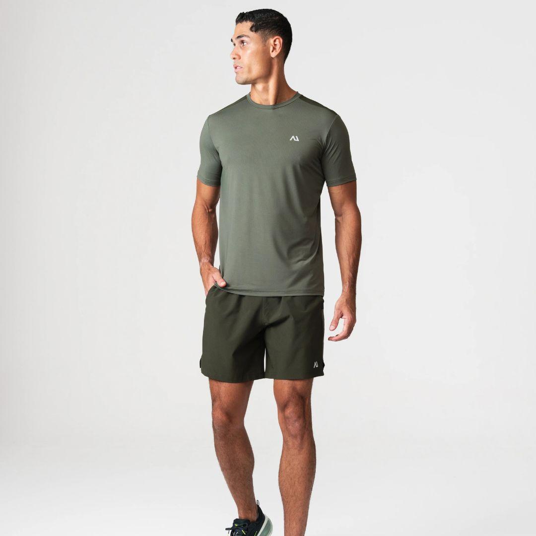 Agaru 'Deep Olive' SRG T-Shirt Set for men, front view on model of olive moisture-wicking seamless tee with Agaru logo and matching dark olive woven shorts