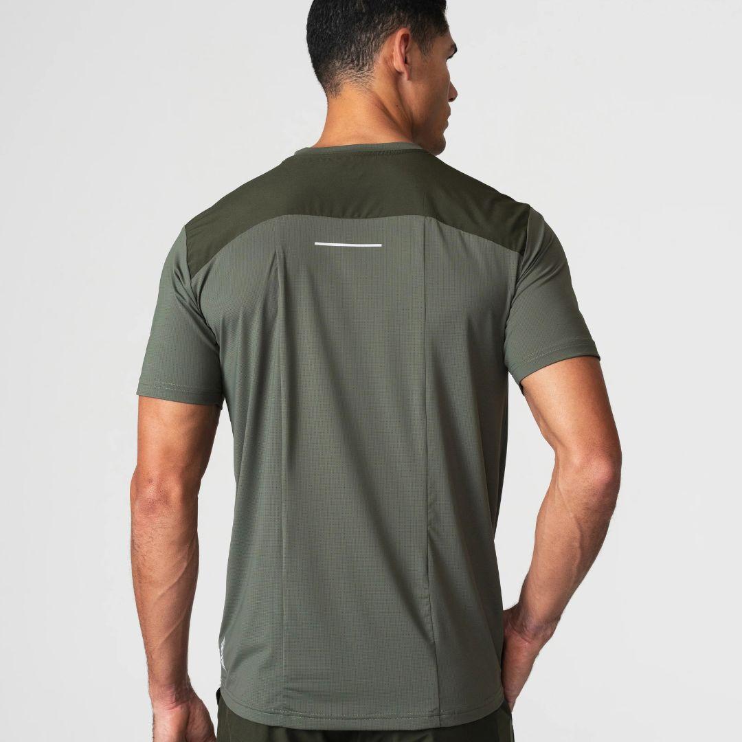 Agaru 'Deep Olive' SRG T-Shirt for men, back view on model showing the panelled shoulder yoke and reflective back strip on the olive seamless tee