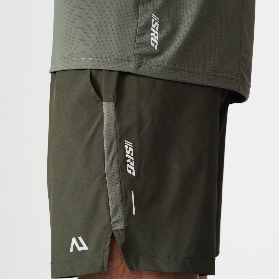 Agaru 'Deep Olive' SRG Shorts for men, close-up of the zipped side pocket, SRG logo print and Agaru branding on the dark olive woven shorts