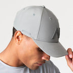 Agaru 'Titanium Grey' SRG Cap for men, close-up side view on model showing the SRG side print and structured cotton crown of the grey cap