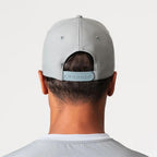 Agaru 'Titanium Grey' SRG Cap for men, back view on model showing the adjustable snap clasp closure on the grey structured cap