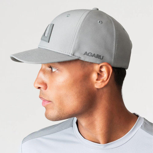 Agaru 'Titanium Grey' SRG Cap for men, side view on model showing the tonal Agaru logo badge and Agaru wordmark on the grey structured cap