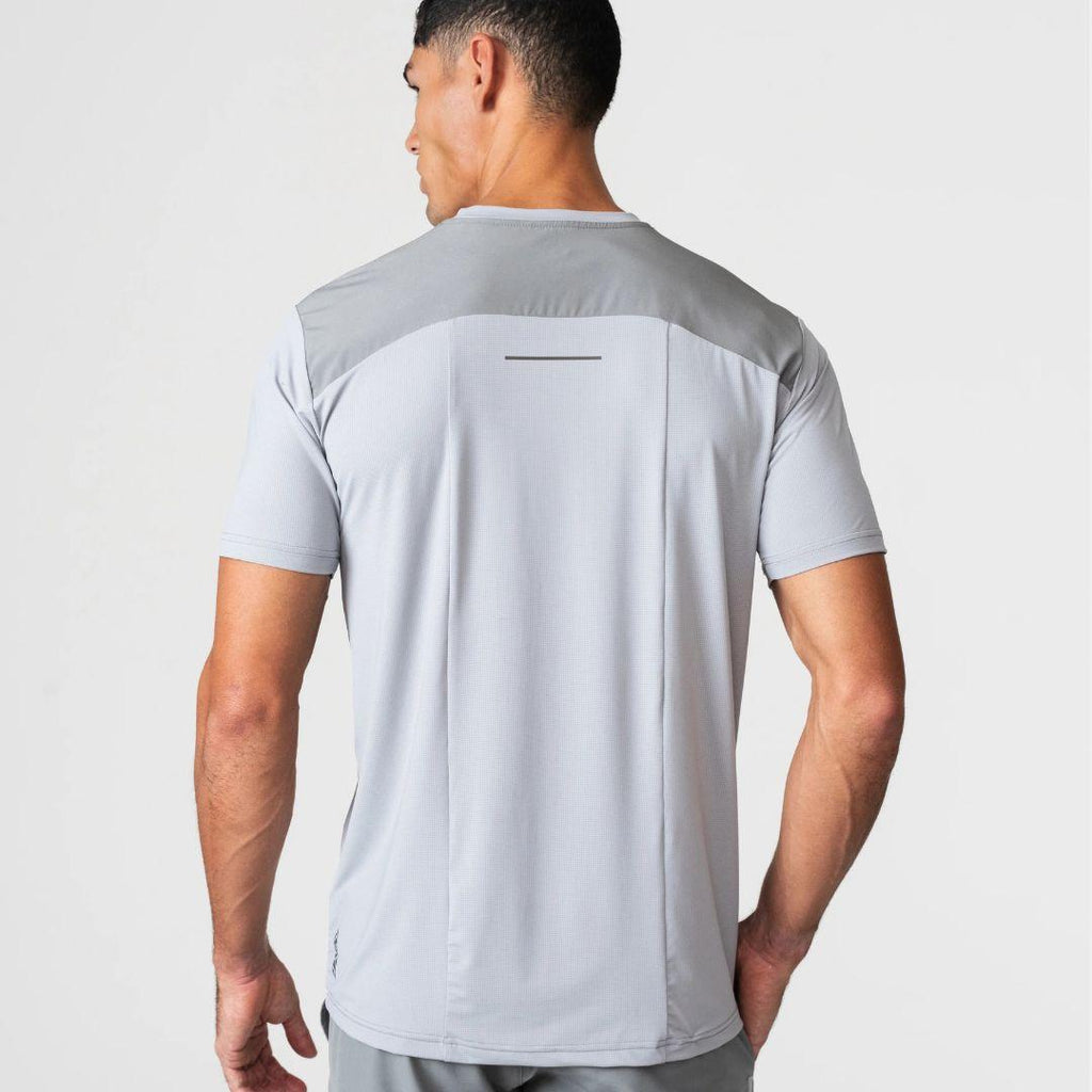 Agaru 'Titanium Grey' SRG T-Shirt for men, back view on model showing the panelled shoulder yoke and reflective back strip on the grey seamless tee