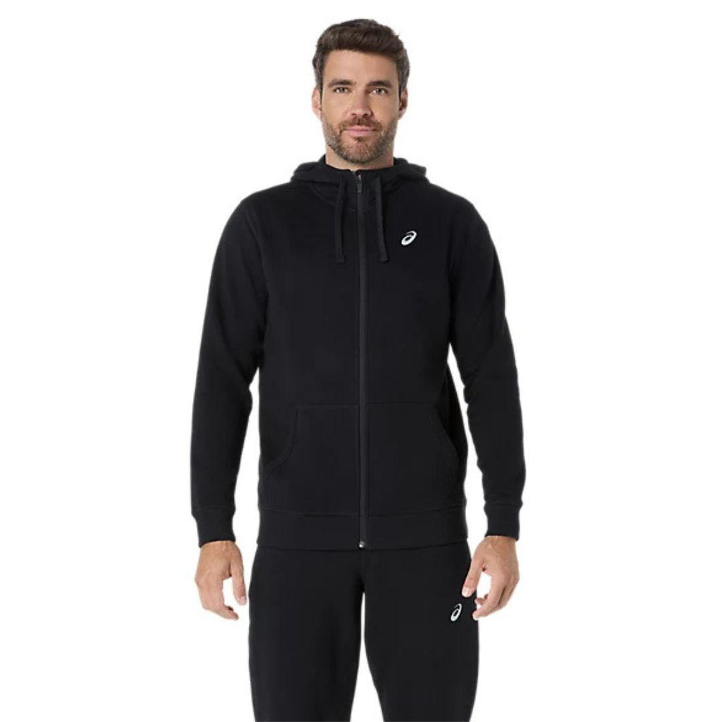 Asics Black Zip Up Hoodie for men, front view on model of black full-zip hoodie with drawcord hood, kangaroo pockets, ribbed cuffs and hem and white Asics logo on the chest