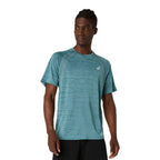 A man wearing a teal heathered athletic t-shirt with a small white Asics logo on the chest, paired with black shorts, against a plain white background.