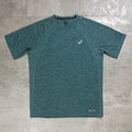 A teal heathered short-sleeve athletic t-shirt with a small white Asics logo on the left chest, laid flat on a gray textured surface.
