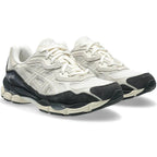 Pair of white and black Asics running shoes on a white background