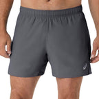A close-up of a person wearing dark gray athletic shorts with an elastic waistband and a small white Asics logo near the lower right leg, shown against a plain white background.
