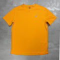 Orange t-shirt with a Asics logo on a gray surface