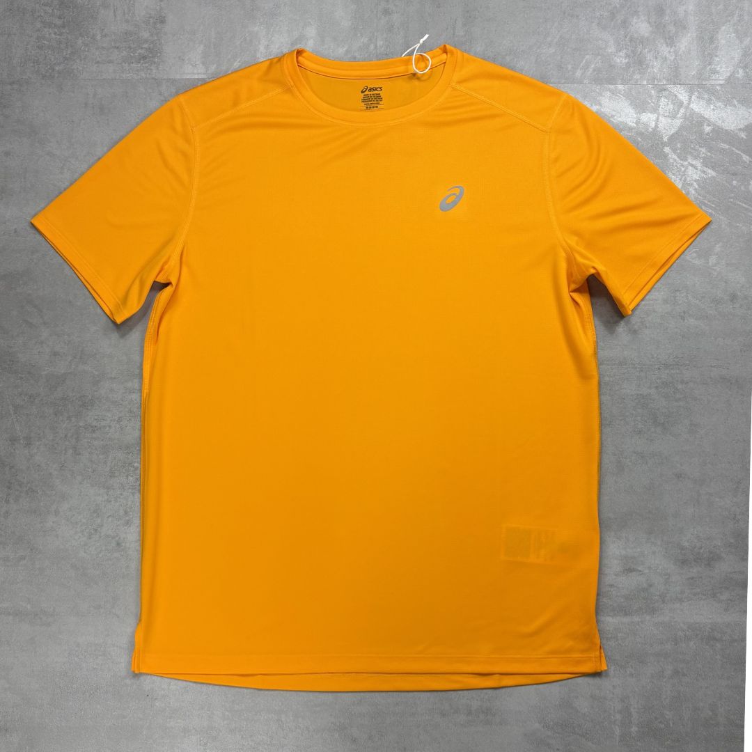 Orange t-shirt with a Asics logo on a gray surface