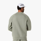 Asics 'Light Green' Sweatshirt for men, back view on model showing the relaxed fit and plain crew neck of the light green fleece sweatshirt