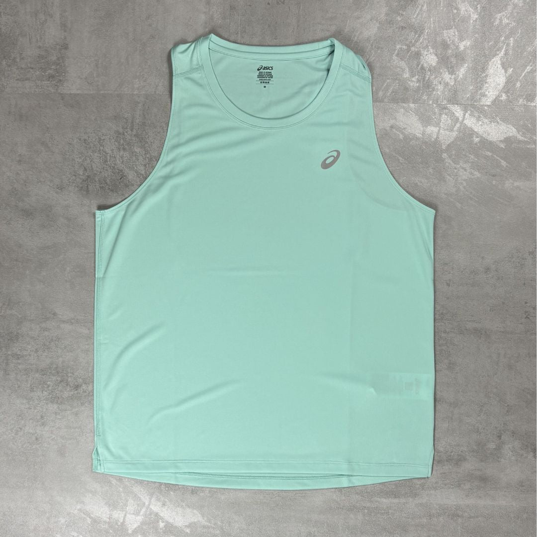 Light blue tank top with a Asics logo on a grey surface