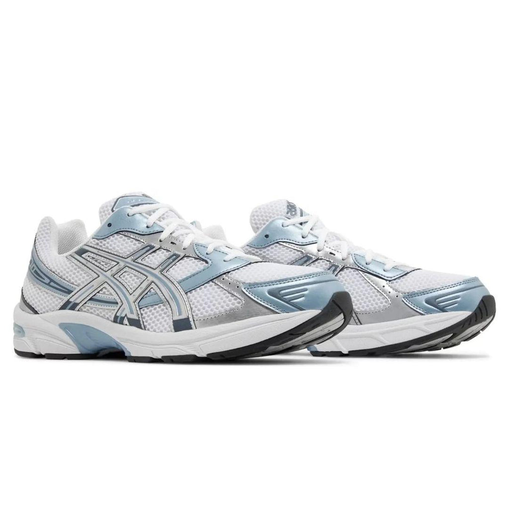 White and light Asics blue running shoes on a white background