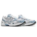 White and light Asics blue running shoes on a white background
