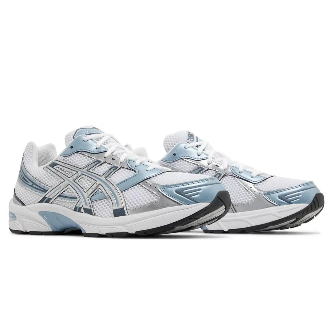 White and light Asics blue running shoes on a white background
