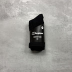 Black sock with Berghaus branding on a gray textured background