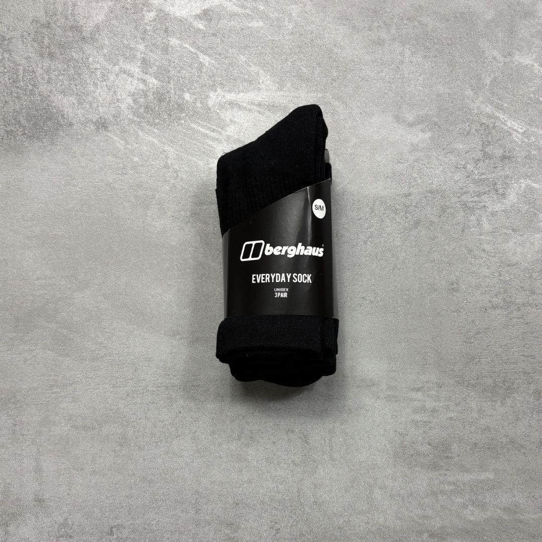 Black sock with Berghaus branding on a gray textured background