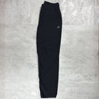 Berghaus Black bottoms layed flat on a grey concrete floor