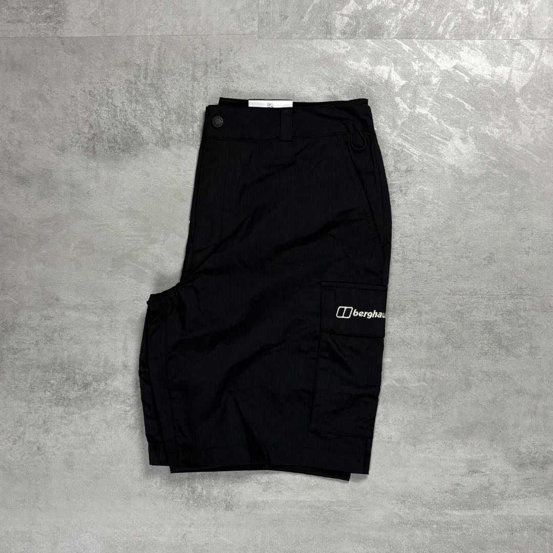 Black shorts with a Berghaus logo on a gray textured surface