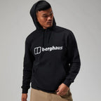 Person wearing a black hoodie with 'berghaus' logo on a gray background