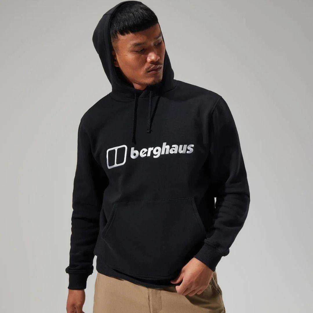 Person wearing a black hoodie with 'berghaus' logo on a gray background