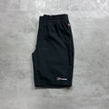 Berghaus Black shorts with a brand logo on a gray concrete surface