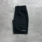 Berghaus Black shorts with a brand logo on a gray concrete surface