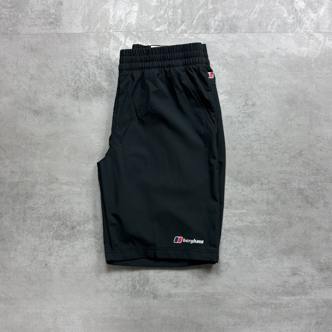 Berghaus Black shorts with a brand logo on a gray concrete surface