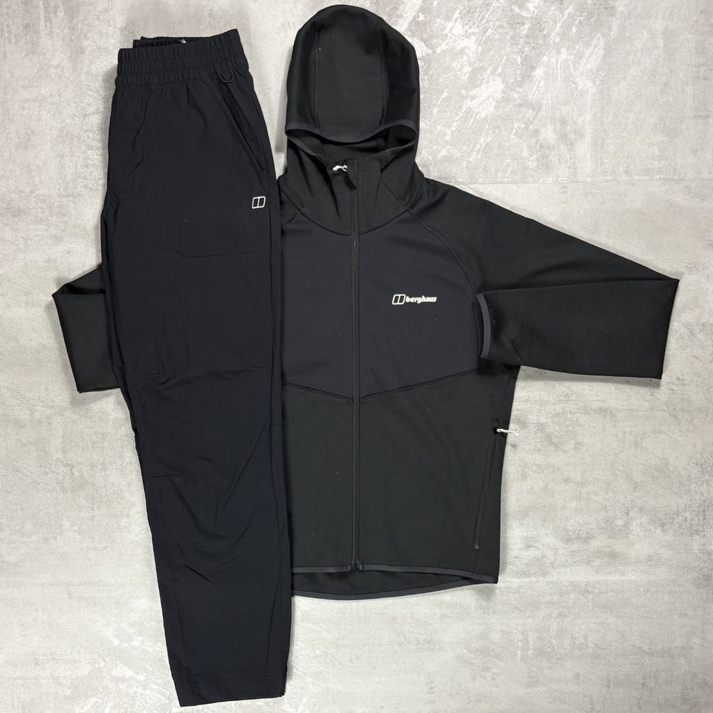 Black jacket and pants set with Berghaus logo on a gray surface