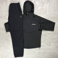Black jacket and pants set with Berghaus logo on a gray surface