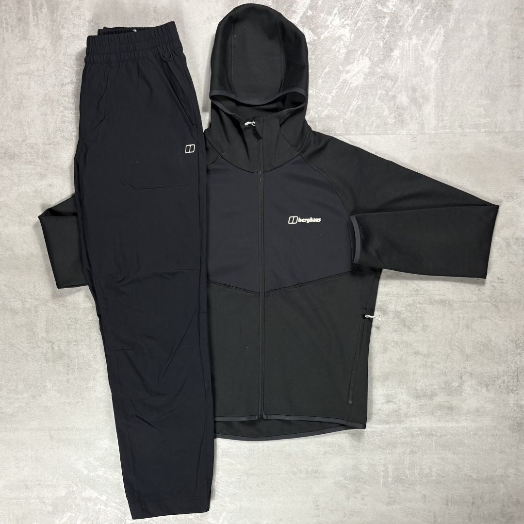 Black jacket and pants set with Berghaus logo on a gray surface
