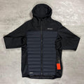 Berghaus Black Vaskye Hooded Hybrid Jacket for men, flat lay on a grey concrete surface of the black full-zip hooded jacket with quilted centre panel and smooth sleeves