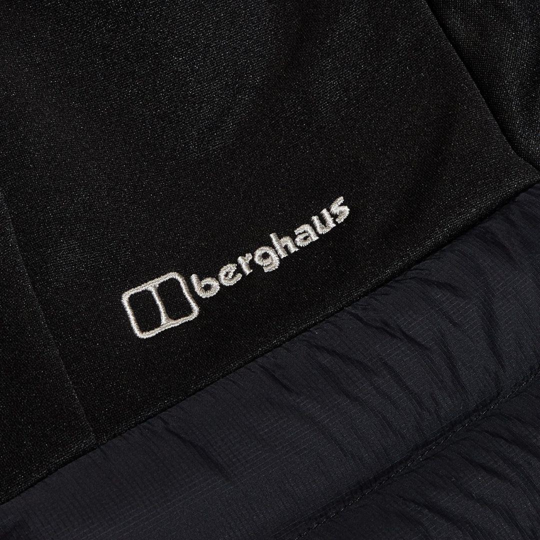 Berghaus Black Vaskye Hooded Hybrid Jacket for men, close-up of the Berghaus logo on the chest where the quilted panel meets the soft sleeve fabric