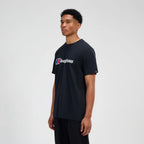 A man wearing a black short-sleeve crewneck t-shirt with a white and red 'begaHaus' logo printed across the chest, standing against a light gray studio background.
