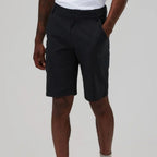A person wearing  Berghaus dark charcoal cargo shorts with a white t-shirt partially visible, shown from the waist down against a light gray studio background.