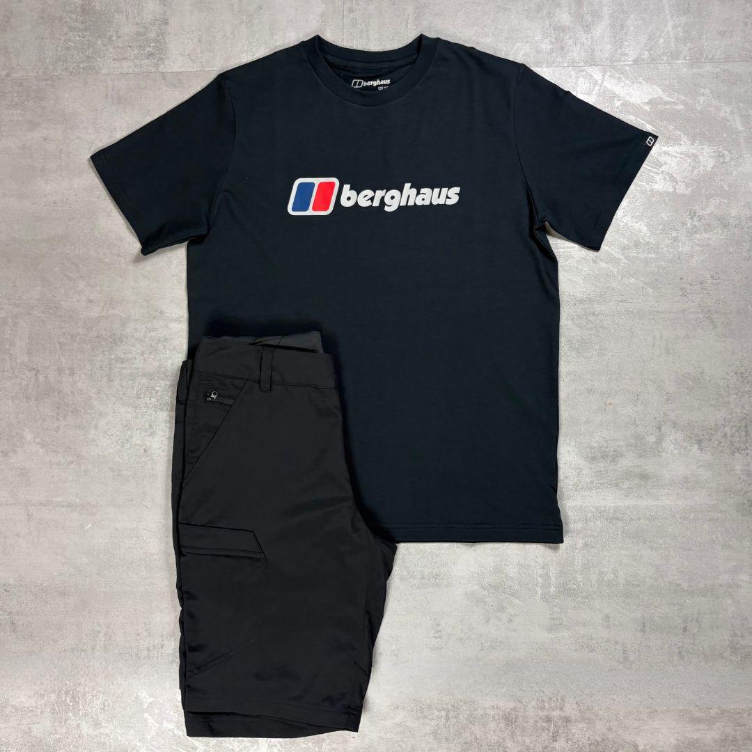 Berghaus Black logo T-shirt paired with Black Navigator shorts on a grey concrete backdrop.