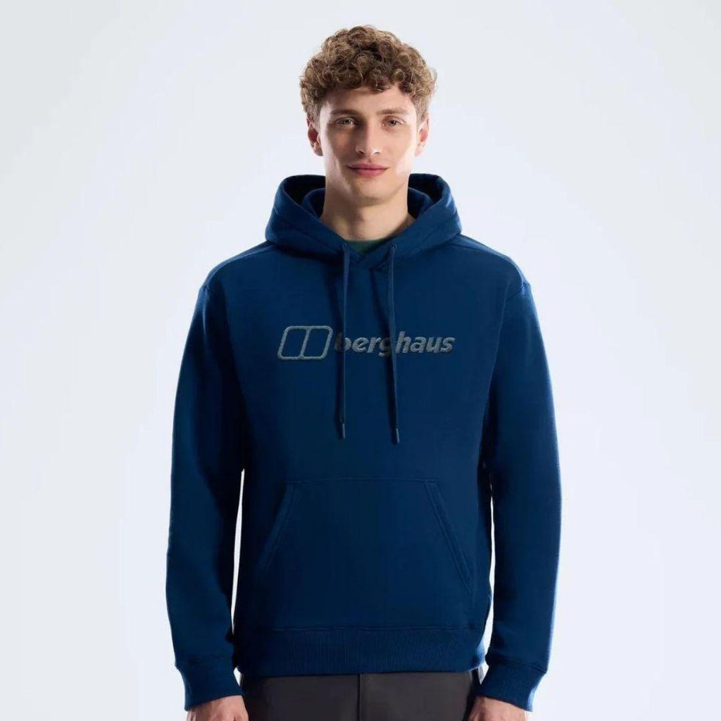 Berghaus 'Dark Blue' Logo Hoodie for men, front view on model of dark blue pullover hoodie with drawcord hood and large Berghaus logo across the chest, part of the 'Dark Blue' Logo Hoodie & Cargo Pant Tracksuit